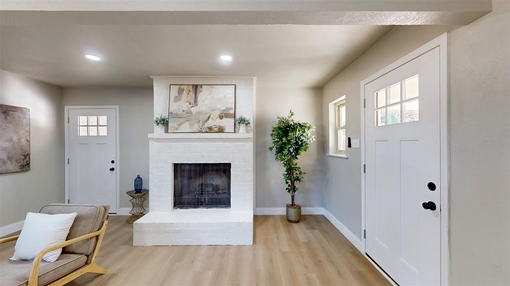5009 Roxie Street Haltom City, TX 76117 - Photo 8 of 39 a living room with furniture and a fireplace