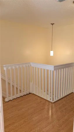 a view of a room with wooden floor and fence