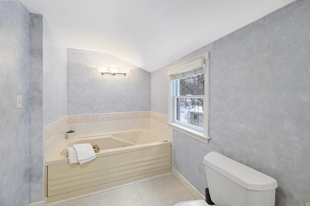 7 Longfellow Road Lexington, MA 02420 - Photo 18 of 30 a bathroom with a bathtub toilet and window