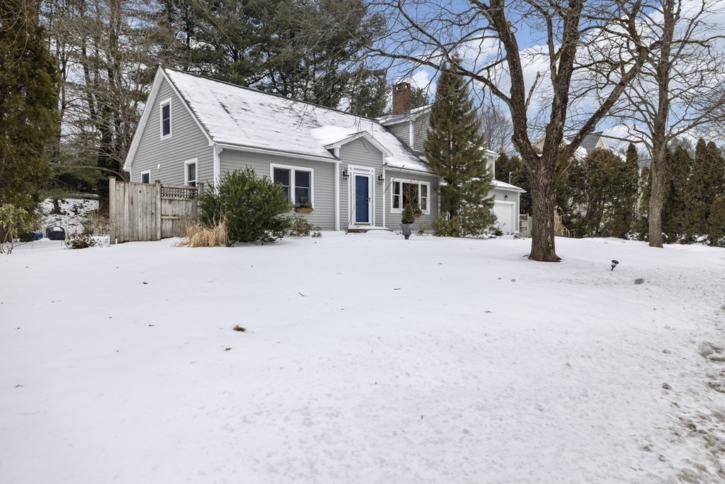 7 Longfellow Road Lexington, MA 02420 - Photo 27 of 30 a view of a white house with a yard covered in snow