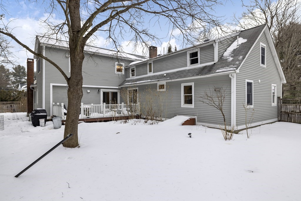 7 Longfellow Road Lexington, MA 02420 - Photo 30 of 30 a view of a white house with a yard covered in snow