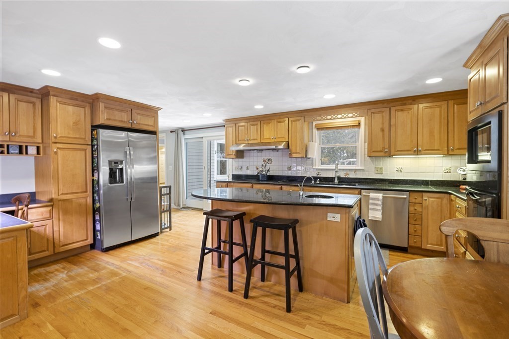 7 Longfellow Road Lexington, MA 02420 - Photo 5 of 30 a kitchen with stainless steel appliances granite countertop a stove a sink a refrigerator white cabinets and wooden floor