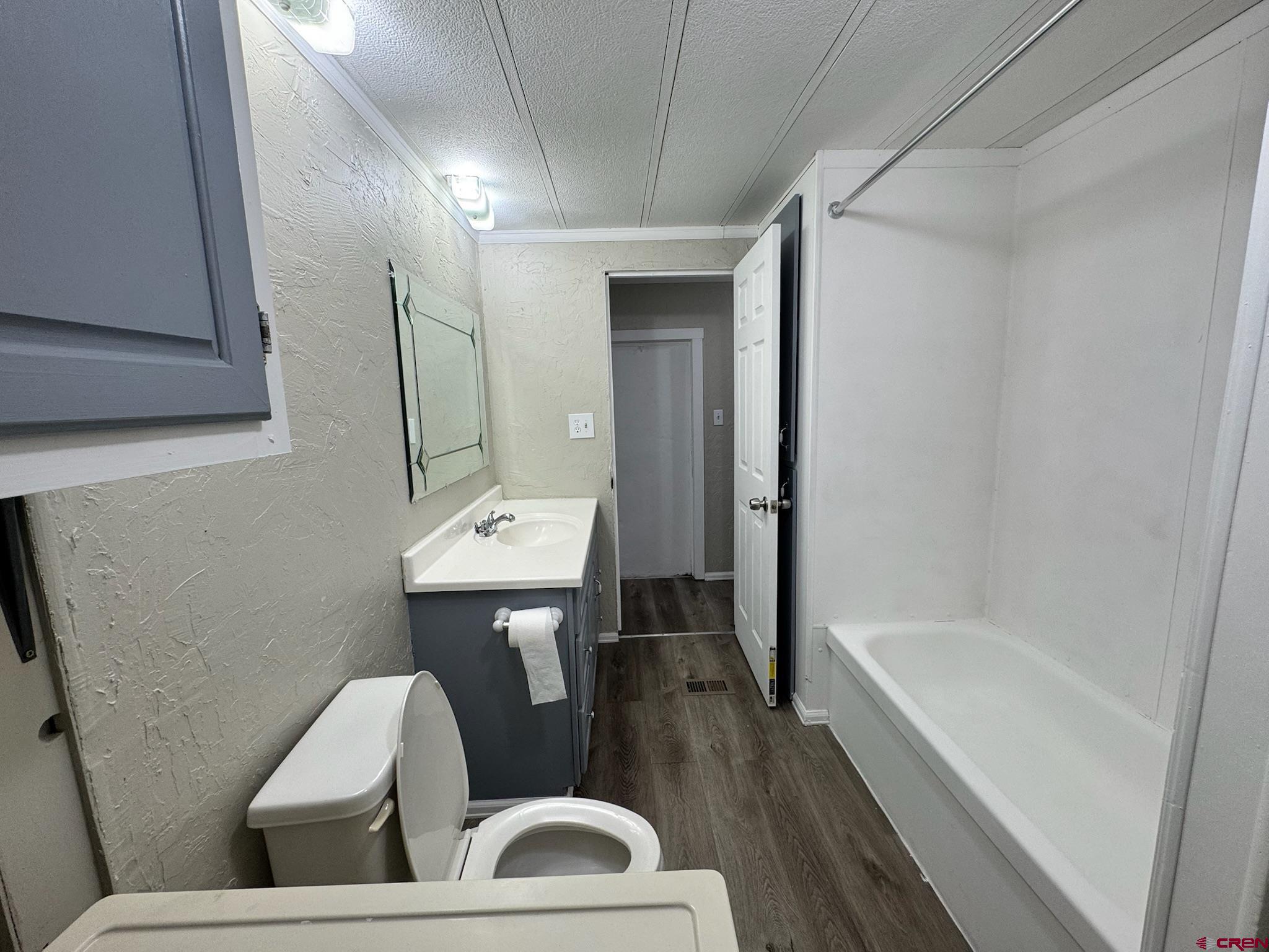 14555 Marine Road, Unit 328 Montrose, CO 81403 - Photo 13 of 20 a bathroom with a sink mirror toilet and bathtub