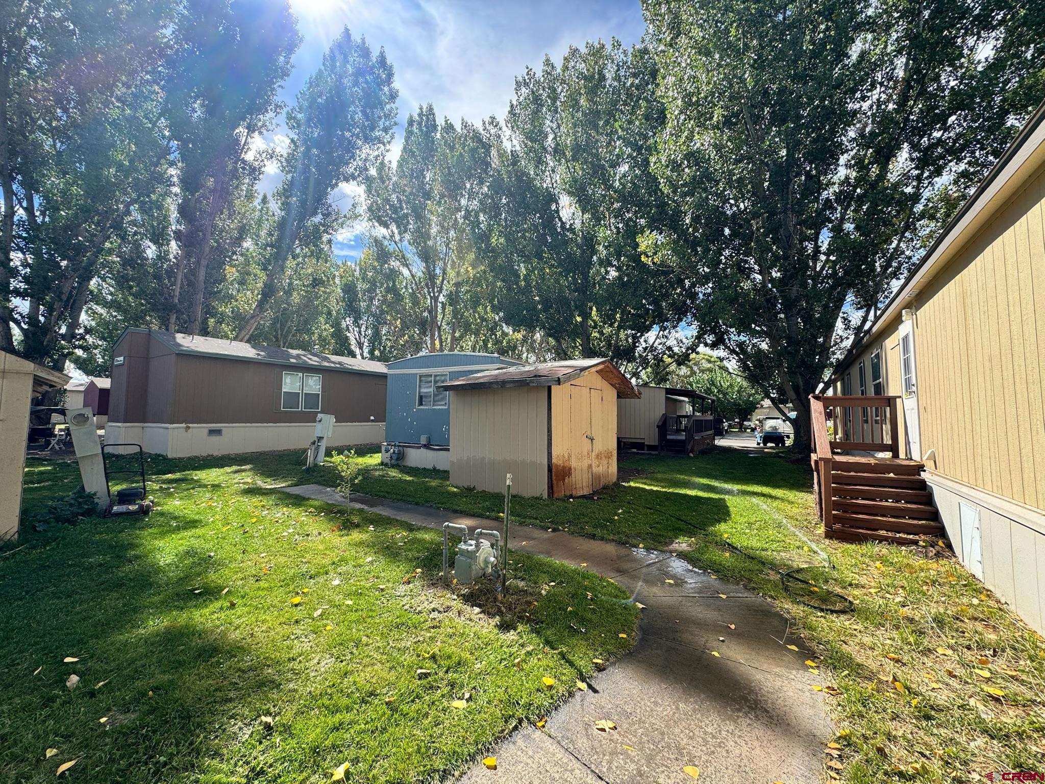 14555 Marine Road, Unit 328 Montrose, CO 81403 - Photo 19 of 20 a backyard of a house with plants and large tree