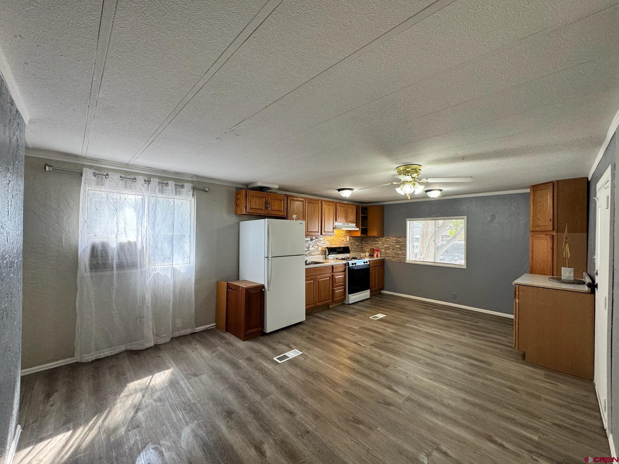 14555 Marine Road, Unit 328 Montrose, CO 81403 - Photo 2 of 20 a view of a kitchen with furniture and wooden floor