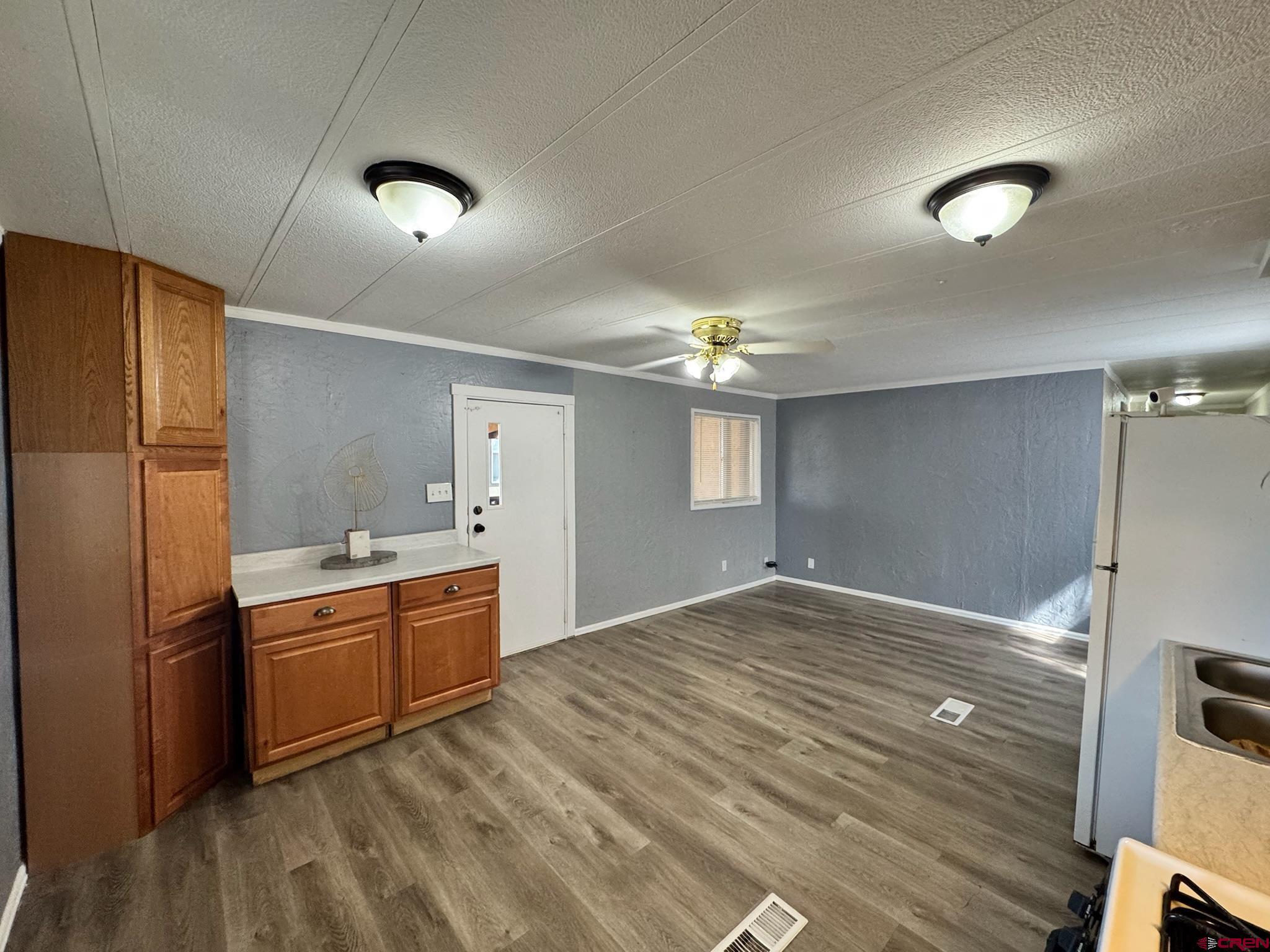 14555 Marine Road, Unit 328 Montrose, CO 81403 - Photo 6 of 20 a kitchen with granite countertop a refrigerator and a sink