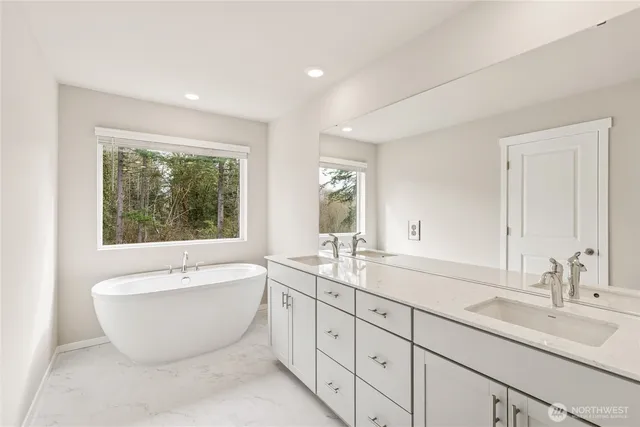 a white bath tub sitting next to a window