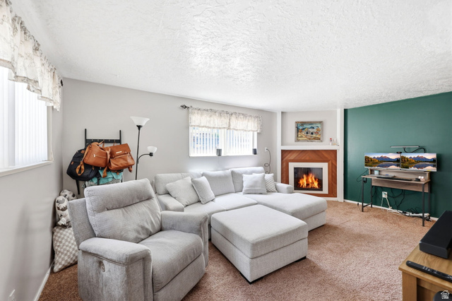 314 West Center Street, Unit F102 Bountiful, UT 84010 - Photo 10 of 29 Living area featuring a fireplace with wood paneling and a white mantel