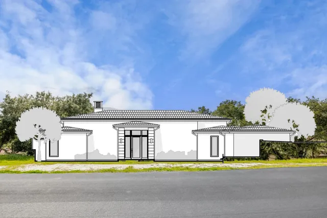 a front view of a house with a garden and yard