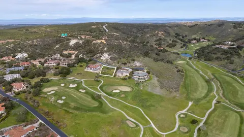 an aerial view of a residential houses with outdoor space