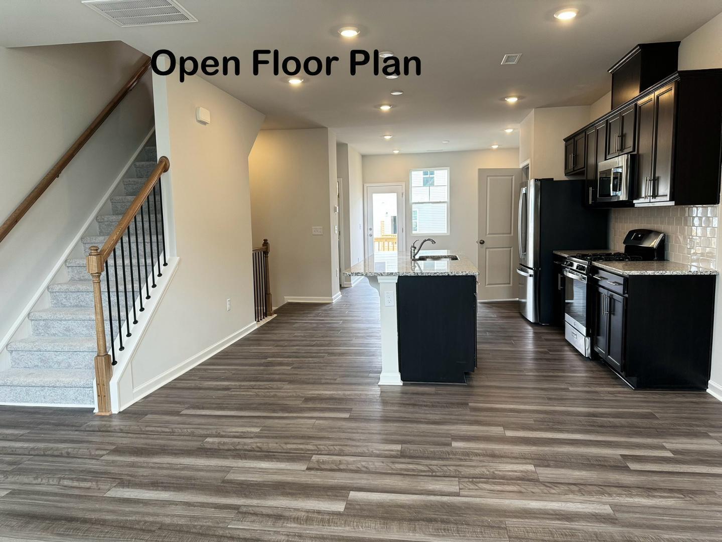 152 Sweet Lilac Way Raleigh, NC 27610 - Photo 17 of 40 a view of a kitchen with cabinets stainless steel appliances and wooden floor