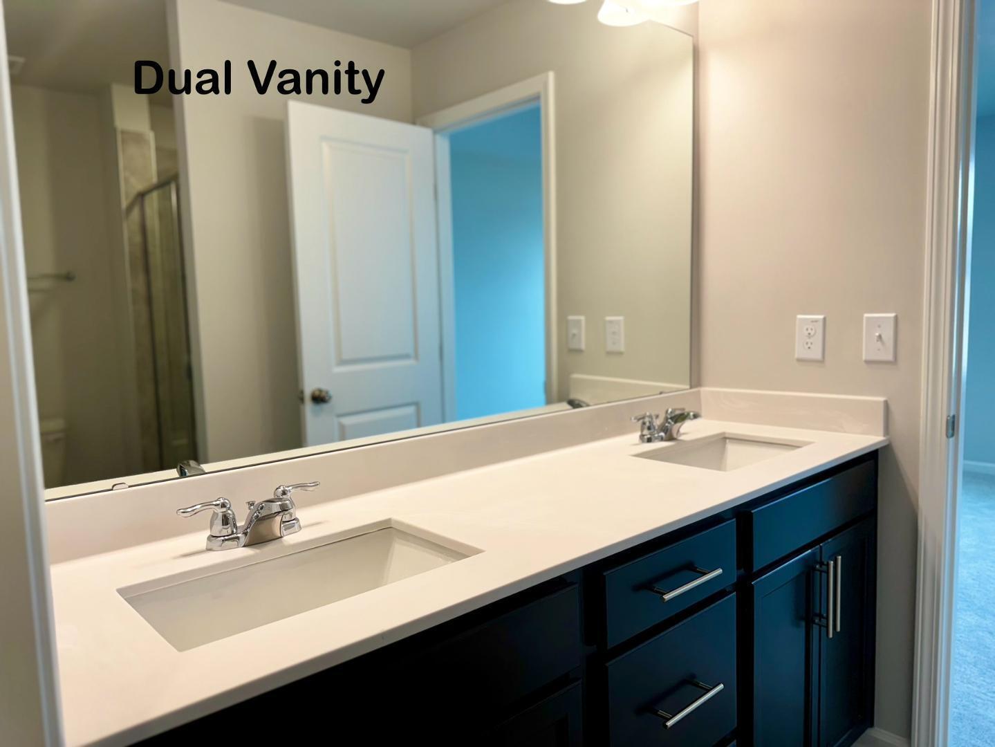 152 Sweet Lilac Way Raleigh, NC 27610 - Photo 21 of 40 a bathroom with a double vanity sink and a mirror