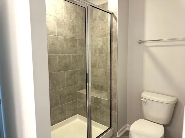 a bathroom with a toilet and a shower