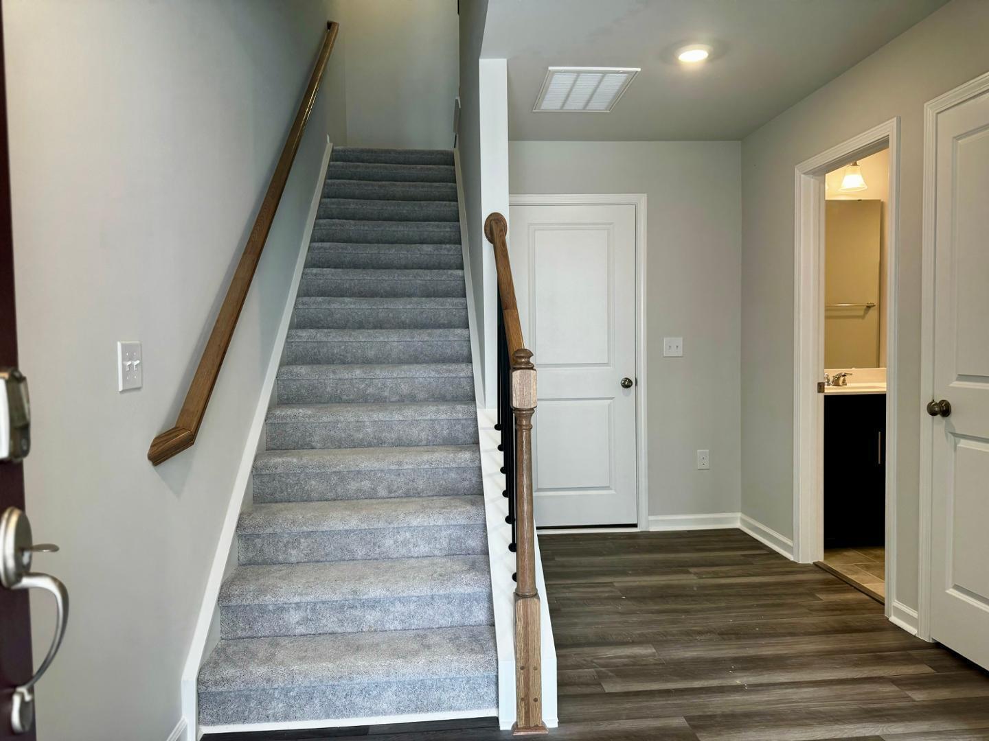 152 Sweet Lilac Way Raleigh, NC 27610 - Photo 4 of 40 a view of an entryway with wooden floor and stairs