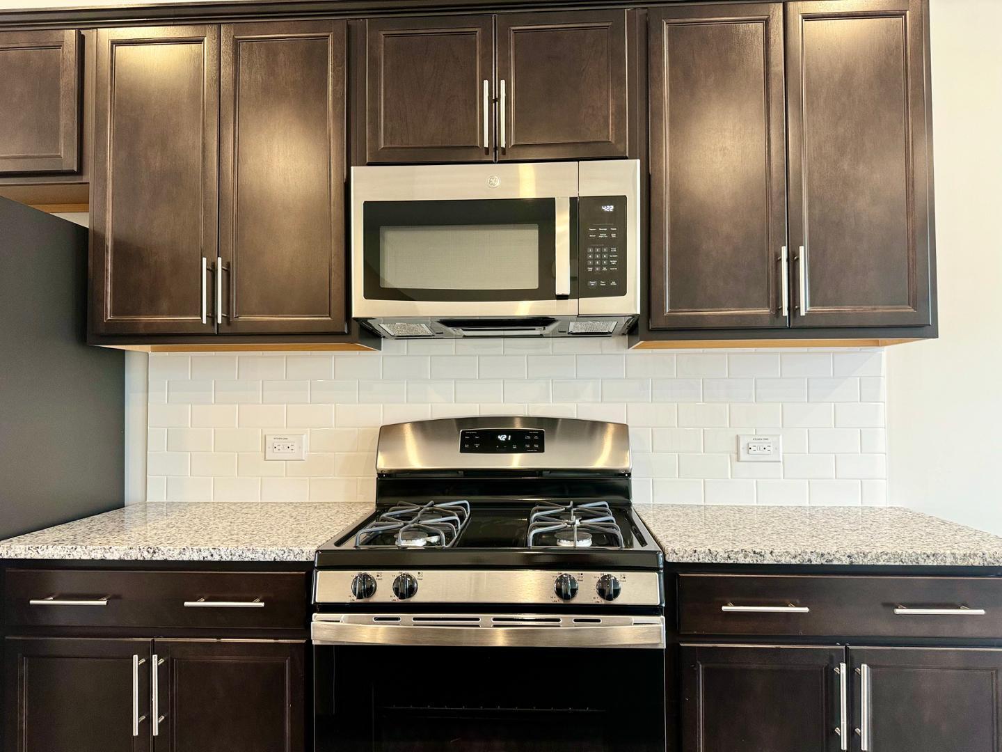 152 Sweet Lilac Way Raleigh, NC 27610 - Photo 10 of 40 a stove top oven sitting inside of a kitchen