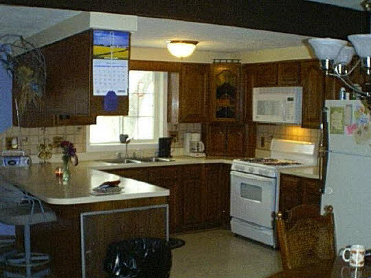 8577 West Winslow Road Durand, IL 61024 - Photo 3 of 6 a kitchen with sink cabinets and stove