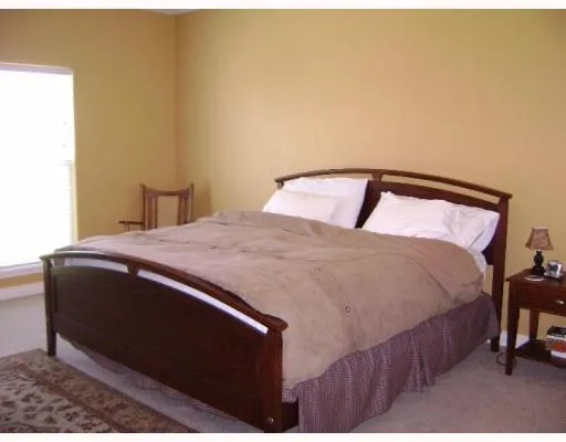 a bedroom with a bed and chair