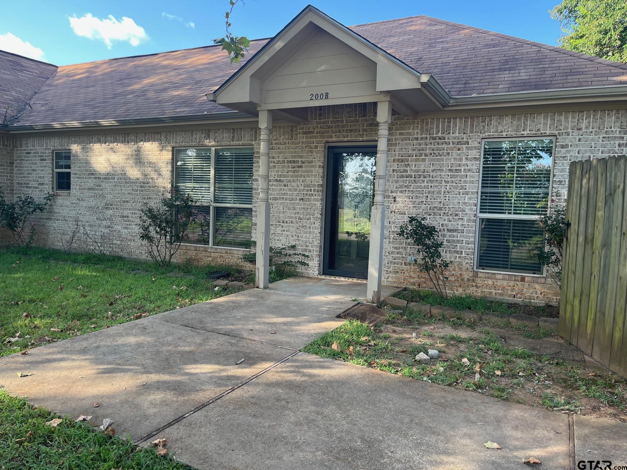 200 Water Street, Unit B Bullard, TX 75757 - Photo 1 of 14 a front view of a house with garden