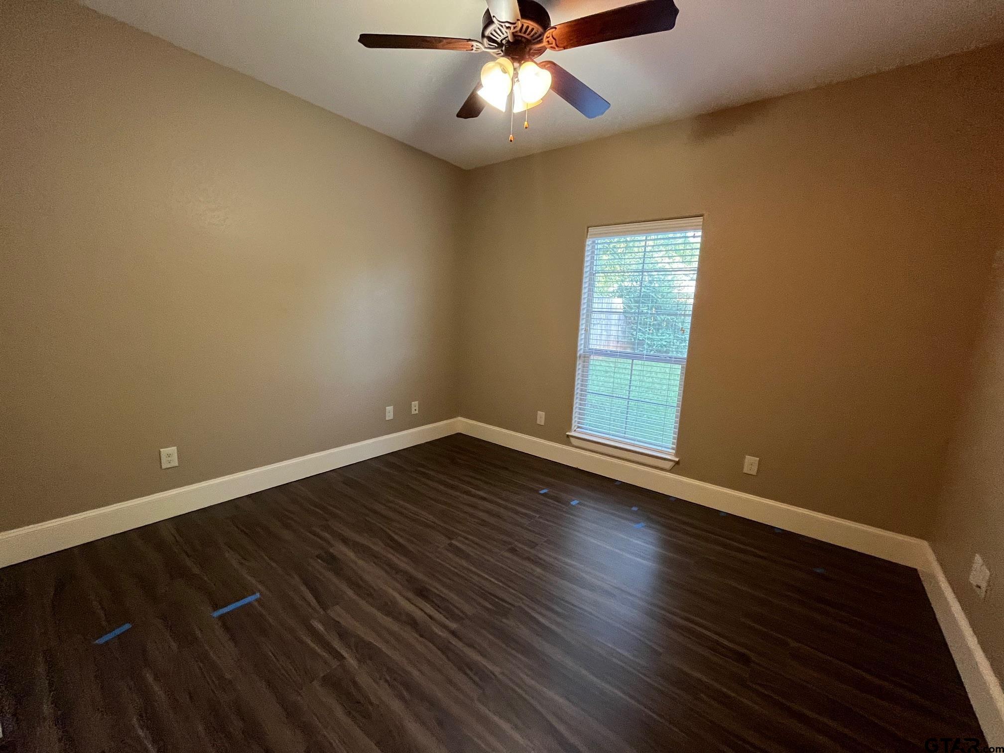 200 Water Street, Unit B Bullard, TX 75757 - Photo 13 of 14 a view of an empty room with wooden floor and a window