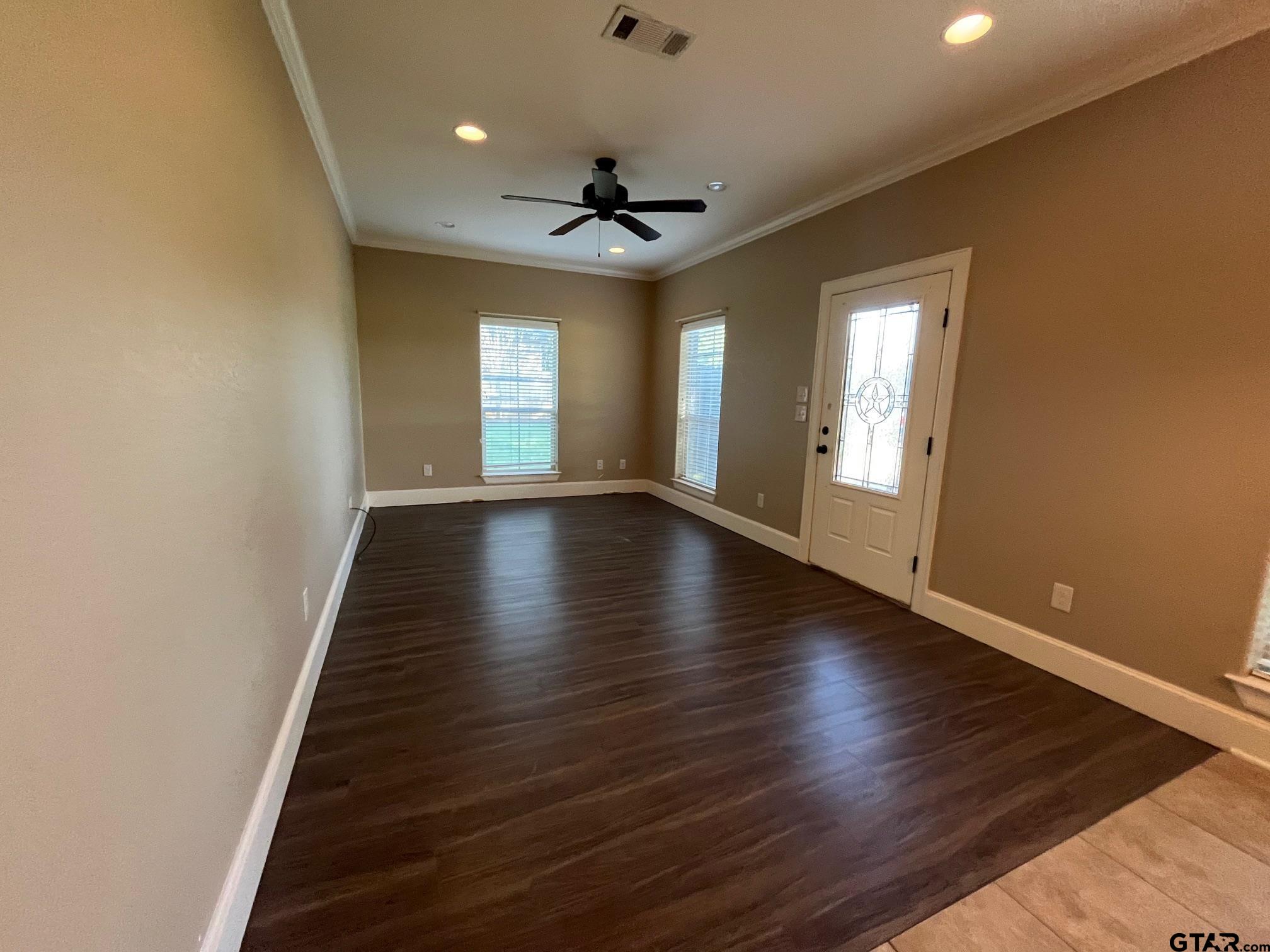 200 Water Street, Unit B Bullard, TX 75757 - Photo 2 of 14 a view of an empty room with a window and wooden floor