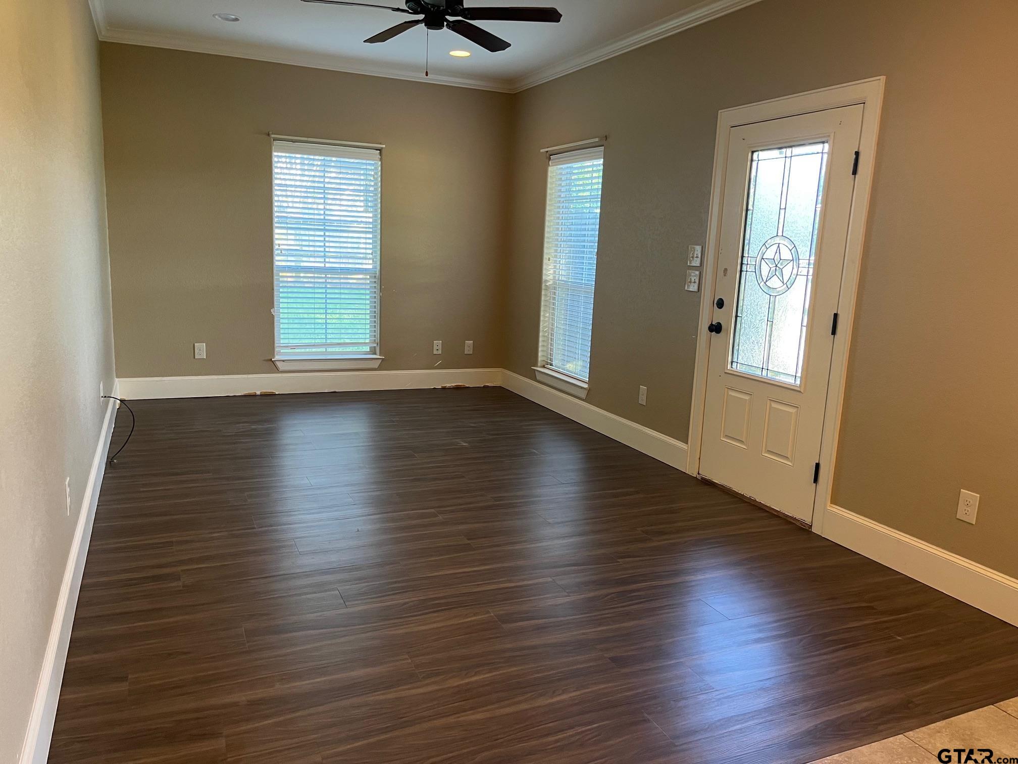 200 Water Street, Unit B Bullard, TX 75757 - Photo 3 of 14 an empty room with wooden floor and windows