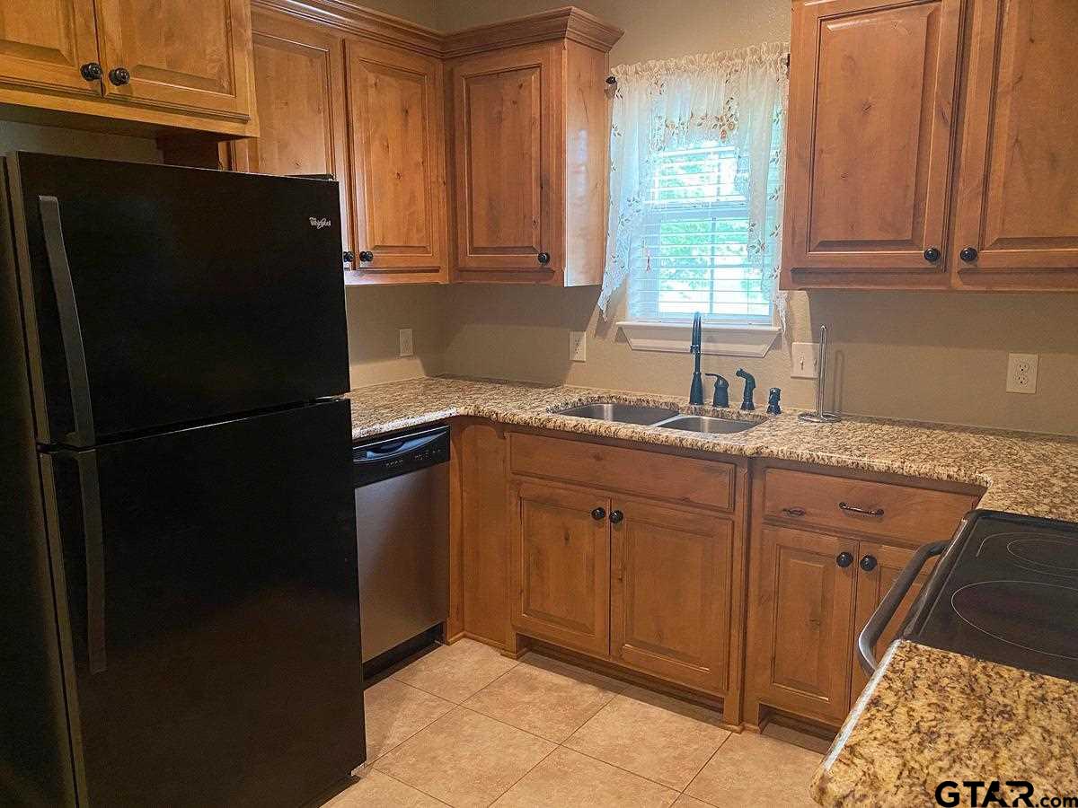 200 Water Street, Unit B Bullard, TX 75757 - Photo 5 of 14 a kitchen with a refrigerator and a sink