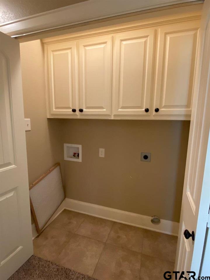 200 Water Street, Unit B Bullard, TX 75757 - Photo 8 of 14 a view of an empty room with wooden floor and cabinet