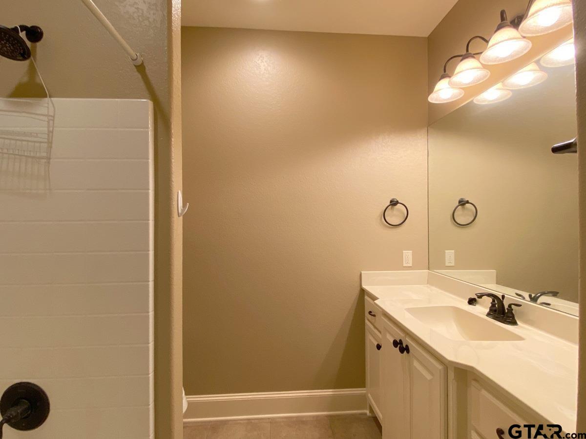 200 Water Street, Unit B Bullard, TX 75757 - Photo 10 of 14 a bathroom with a sink a mirror and a bathtub