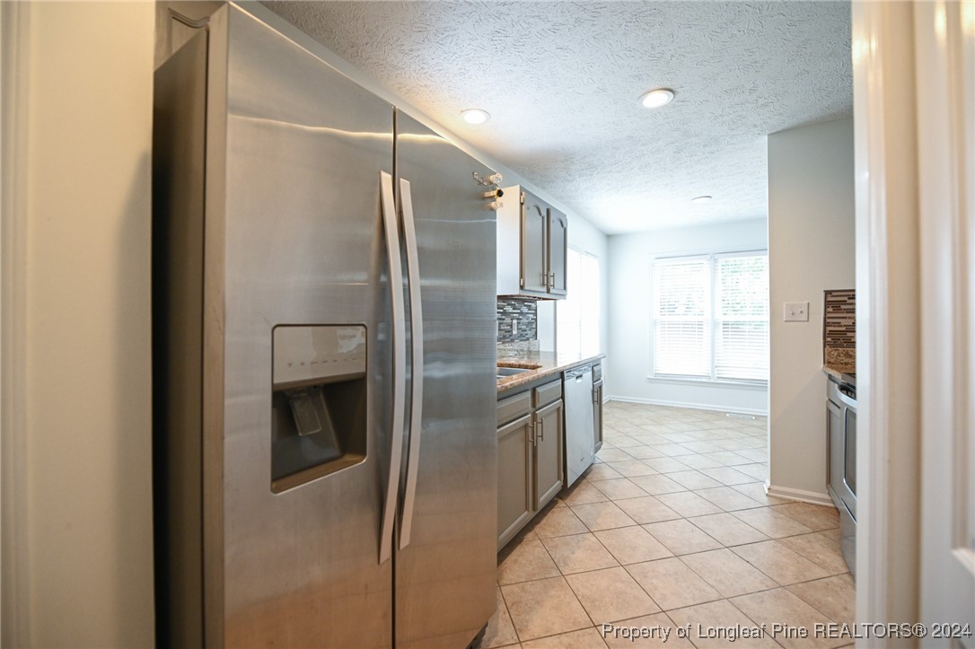 5057 Summer Ridge Road Fayetteville, NC 28303 - Photo 15 of 29 a kitchen with stainless steel appliances a refrigerator and a sink