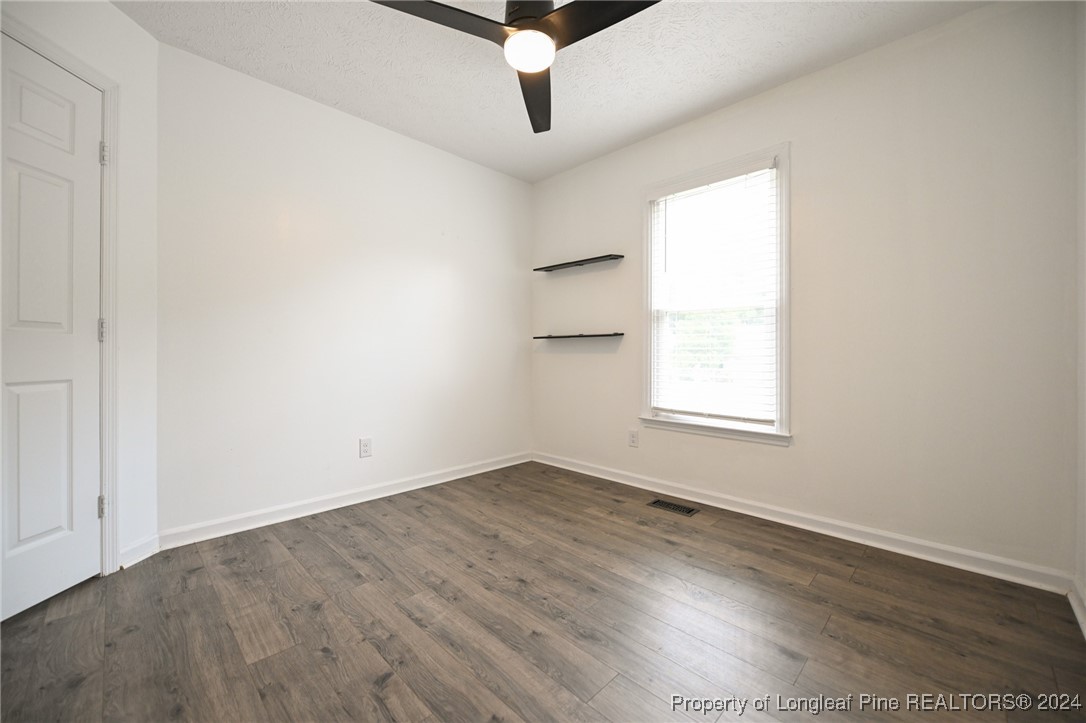5057 Summer Ridge Road Fayetteville, NC 28303 - Photo 22 of 29 an empty room with wooden floor and windows