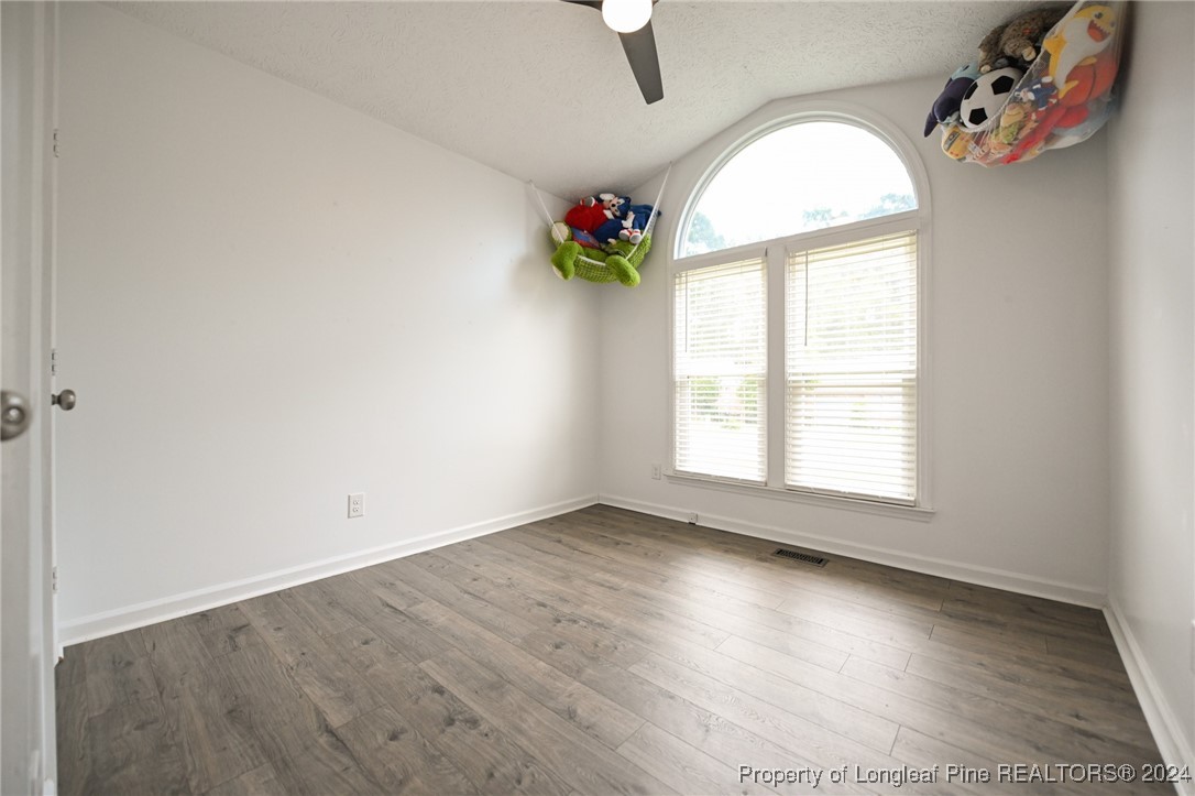 5057 Summer Ridge Road Fayetteville, NC 28303 - Photo 24 of 29 an empty room with wooden floor and windows