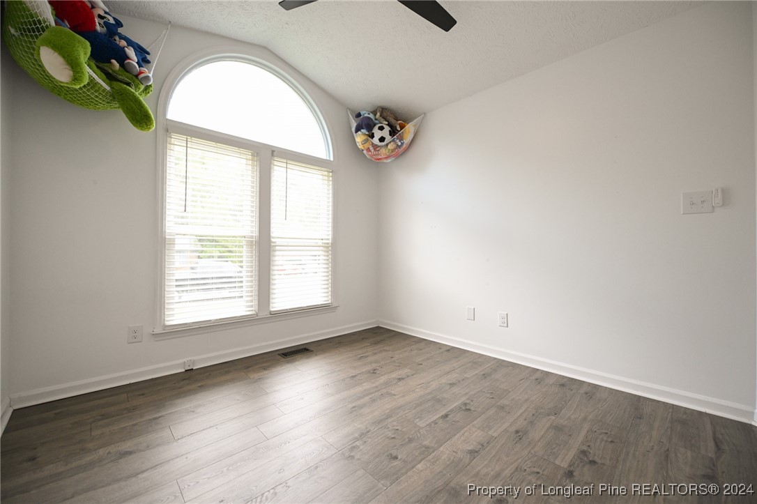 5057 Summer Ridge Road Fayetteville, NC 28303 - Photo 25 of 29 an empty room with wooden floor and windows