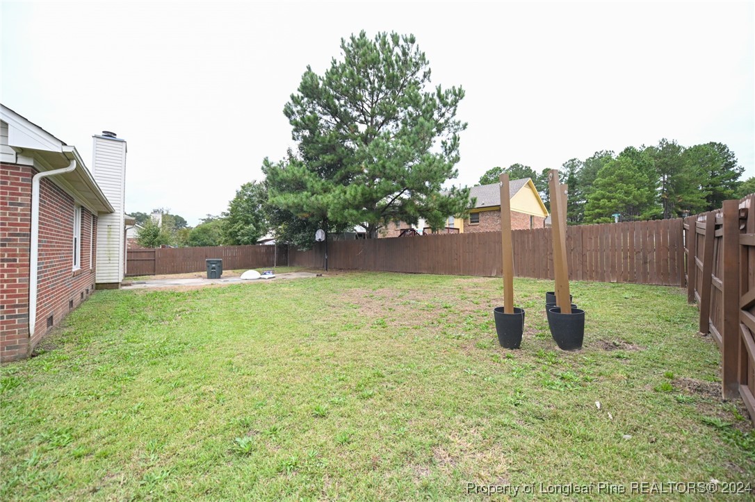 5057 Summer Ridge Road Fayetteville, NC 28303 - Photo 26 of 29 a backyard of a house with lots of green space