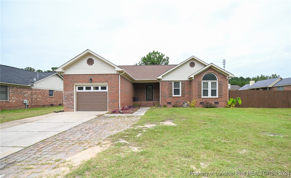 5057 Summer Ridge Road Fayetteville, NC 28303 - Photo 3 of 29 a front view of a house with a yard and garage