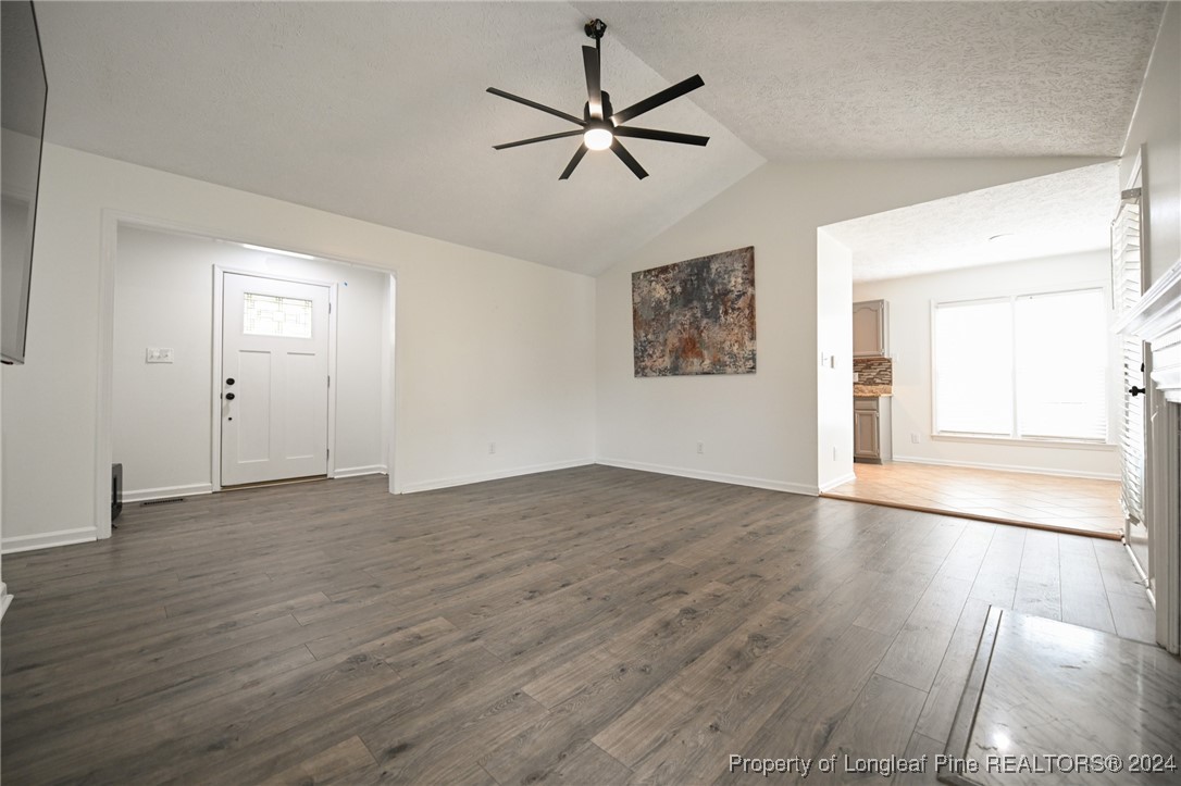 5057 Summer Ridge Road Fayetteville, NC 28303 - Photo 8 of 29 an empty room with wooden floor ceiling fan and windows