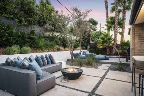 a view of a couches with potted plants on it