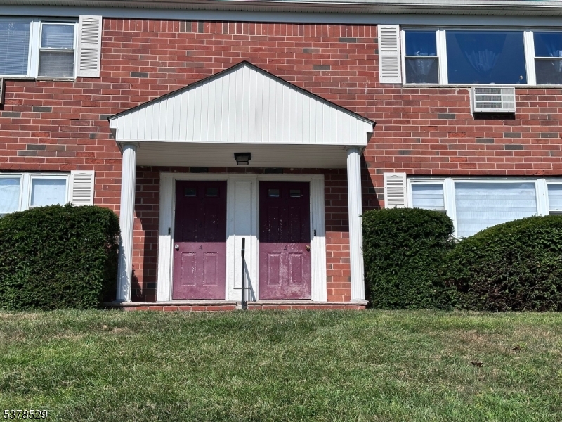 2467 Highway 10, Unit 6B Morris Plains, NJ 07950 - Photo 3 of 18 a front view of a house with a garden