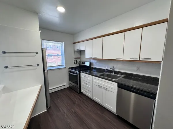 a kitchen with stainless steel appliances a sink dishwasher stove refrigerator and microwave