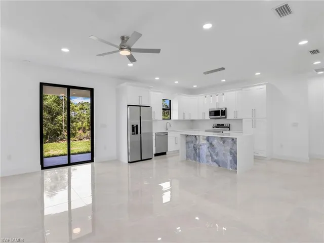 a view of kitchen with stainless steel appliances refrigerator oven and cabinets