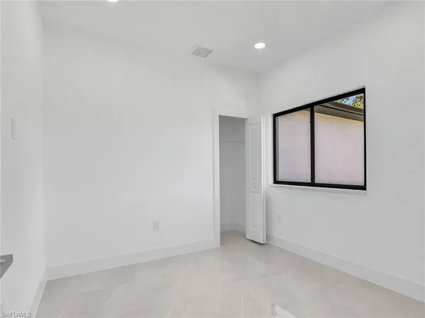 a view of an empty room with wooden door