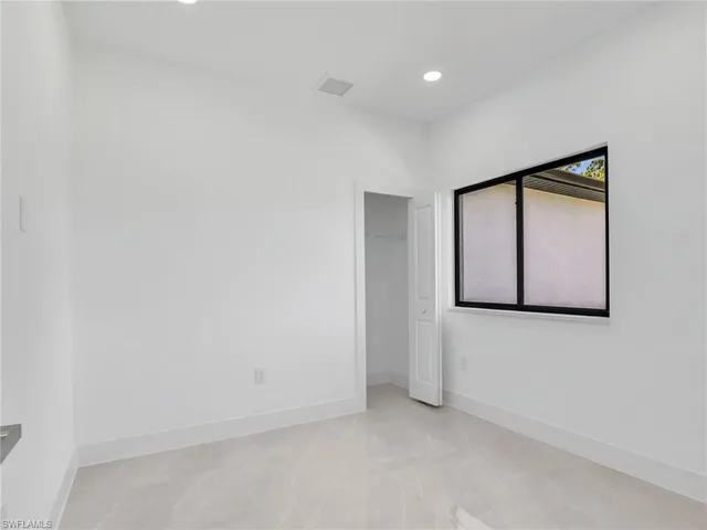 a view of an empty room with wooden door