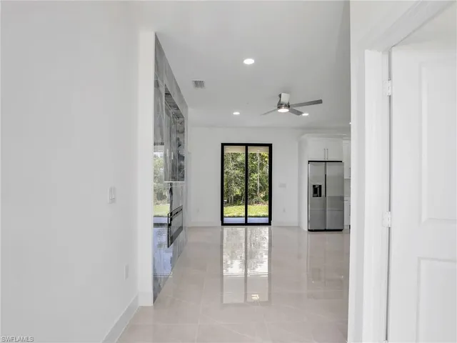 a view of a hallway with wooden shelves and windows