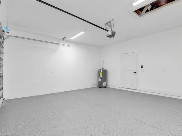 an empty room with ceiling fan and windows