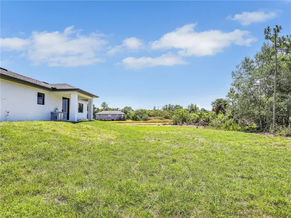 a front view of house with yard and trees