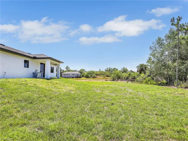 a front view of house with yard and trees