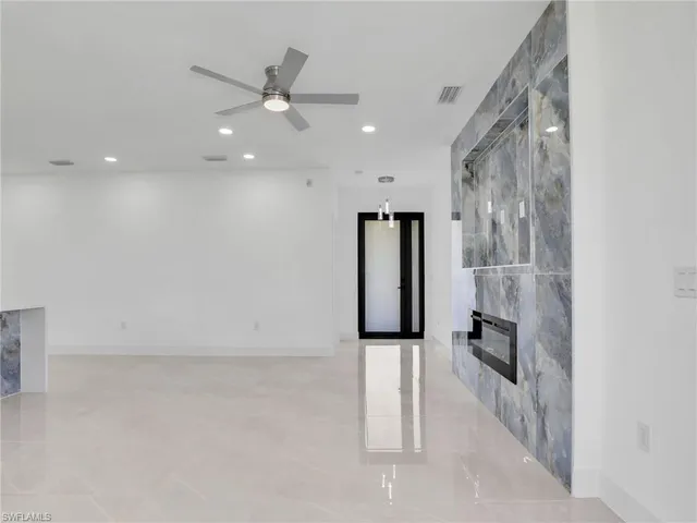 a view of a hallway with a ceiling fan