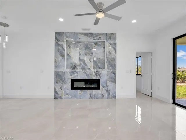 an empty room with fireplace and windows