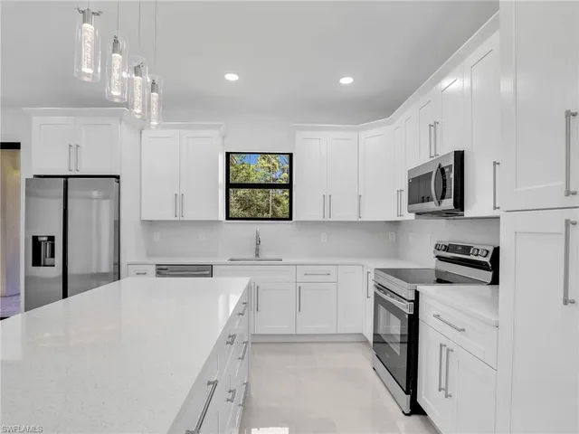 a kitchen with cabinets stainless steel appliances and a counter top space