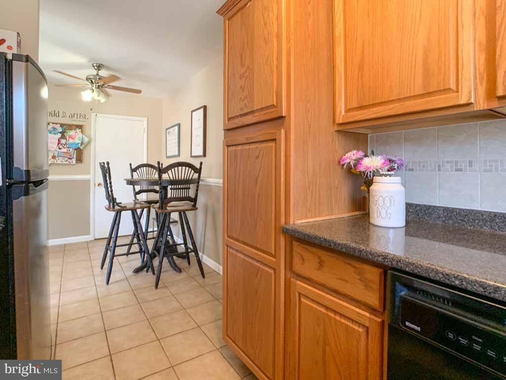 1148 Morefield Road Philadelphia, PA 19115 - Photo 12 of 35 a kitchen with stainless steel appliances granite countertop a refrigerator and a stove top oven