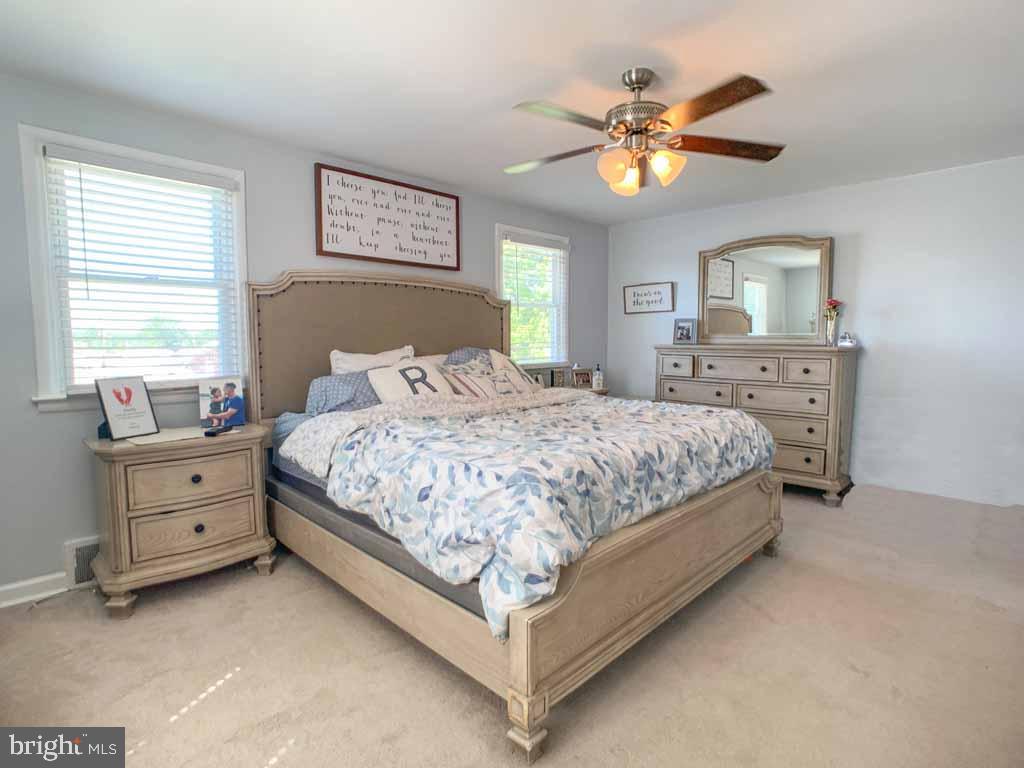 1148 Morefield Road Philadelphia, PA 19115 - Photo 15 of 35 a bedroom with a bed and a chandelier